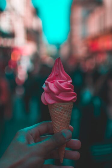 person holding strawberry ice cream